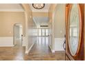 Inviting foyer features hardwood floors and arched doorways, leading to a bright living area with multiple windows at 384 Minix Rd, Sharpsburg, GA 30277