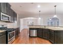 This stylish kitchen features granite countertops, stainless steel appliances, hardwood floors, and recessed lighting at 4719 Joseph Eli Dr, Snellville, GA 30039