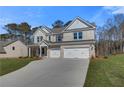 Attractive two-story home featuring a three-car garage and well-kept landscaping at 124 Felicity Pike, Locust Grove, GA 30248