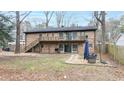 Spacious backyard with a deck, patio, and stairs leading to the upper level at 1343 Renee Dr, Decatur, GA 30035