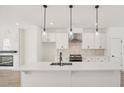Modern kitchen with white cabinets, stainless steel appliances, and island at 1092 Glen Opal Dr, Decatur, GA 30032