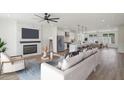 Open concept living area with fireplace, ceiling fan, and modern kitchen at 1092 Glen Opal Dr, Decatur, GA 30032