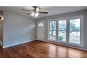 Inviting living room featuring hardwood floors, large windows, and a ceiling fan at 1098 Laurel Nw Ln, Conyers, GA 30012