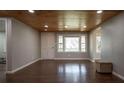 Bright, open living room with beautiful hardwood floors, wooden ceilings, and recessed lighting at 3642 Highway 81, Oxford, GA 30054