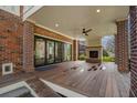 Covered brick patio with ceiling fan, fireplace, and bi-folding glass doors for seamless indoor/outdoor living at 914 Adair Ne Ave, Atlanta, GA 30306