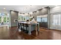 Modern kitchen with stainless steel appliances, a center island with barstool seating, and hardwood floors at 914 Adair Ne Ave, Atlanta, GA 30306