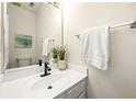Clean and simple half bathroom with a white vanity, modern fixtures, and neutral decor for a minimalist design at 240 Leasingworth Way, Roswell, GA 30075