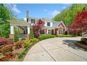 Charming two-story home with a covered porch and beautifully landscaped front yard at 1790 Mountain Farm Rd, Woodstock, GA 30188