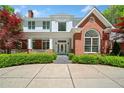 Beautiful home with brick and white facade, manicured landscaping, and a welcoming entrance at 1790 Mountain Farm Rd, Woodstock, GA 30188