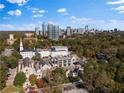 City skyline and treetop view with charming churches below on a beautiful day with clouds in the bright, blue sky at 2626 Peachtree Nw Rd # 704, Atlanta, GA 30305