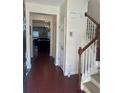 Open foyer with hardwood floors, staircase, and views into the dining and living spaces at 2555 Flat Shoals Rd # 2006, Atlanta, GA 30349