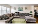 Inviting living room with a large sectional couch with decorative pillows, and bright natural light at 795 Hammond Dr # 813, Sandy Springs, GA 30328