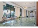 Bright lobby with large windows, elegant seating, and marble floors at 795 Hammond Dr # 813, Sandy Springs, GA 30328