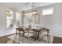Bright dining room with modern chandelier, neutral tones, and views of the outdoors at 11894 Aspen Forest Dr, Johns Creek, GA 30005