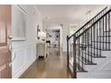 Elegant foyer with hardwood floors, staircase, and wainscoting, leading to a spacious living area at 11894 Aspen Forest Dr, Johns Creek, GA 30005