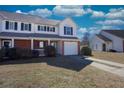 Lovely townhome exterior features brick accents, attached garage and a grassy front yard at 269 Cottonwood Creek Cir, Canton, GA 30114