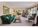 Elegant living room with traditional furnishings, neutral carpet, and a large window at 5443 Dunwoody Knoll Ct, Dunwoody, GA 30338