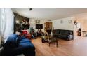 Spacious living room showcasing wood floors, stone fireplace, and a comfortable seating arrangement at 5461 Chuzzlewit Sw Ct, Lilburn, GA 30047
