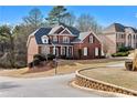Charming two-story brick home with a well-manicured lawn and professional landscaping at 3000 Shade Tree Ct, Villa Rica, GA 30180
