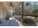 View of the covered back porch with seating and scenic surroundings at 8245 Mill Run Trl, Whitesburg, GA 30185
