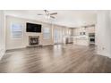 Open-concept living room featuring a fireplace and seamless connection to the modern kitchen at 9106 Hanover Street St, Lithia Springs, GA 30122