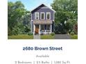 Charming two-story home with blue siding, a cozy porch, and well-maintained landscaping at 2680 Brown Nw St, Atlanta, GA 30318