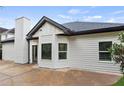 Rear exterior view of home showing the light siding and dark trim details at 100 Jericho Dr, Covington, GA 30016