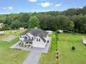 Beautiful two-story home features a lush green lawn and convenient outbuildings, perfect for storage or hobbies at 709 Mohansic Ave, Loganville, GA 30052