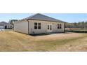 The home features a large, flat backyard with a small concrete patio and double doors at 8592 Secretariat Dr, Lithonia, GA 30058