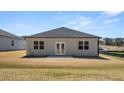 The home features a large, flat backyard with a small concrete patio and double doors at 8592 Secretariat Dr, Lithonia, GA 30058
