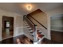 Welcoming foyer with hardwood floors, staircase with carpet runner, and elegant light fixture at 1261 William Robert Sw Dr, Marietta, GA 30008