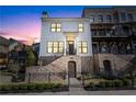 Beautiful modern farmhouse with a brick foundation, black iron fence, and professional landscaping at 1311 English Nw St, Atlanta, GA 30318