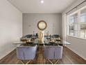 Modern dining room with a glass table, stylish chairs, and ample natural light from a large window at 204 Oak View Ln, Dallas, GA 30157