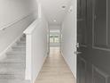 Hallway that leads to the living room with an elegant stairway with carpet at 206 Oak View Ln, Dallas, GA 30157