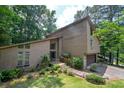 Lovely home with mature trees and a charming walkway and garage entrance at 2235 Six Branches Dr, Roswell, GA 30076