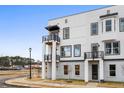 Stylish townhome featuring a contemporary design with balconies, contrasted by a clear blue sky at 1084 Brookglynn Trce, Decatur, GA 30032