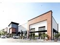 Modern commercial building with a combination of white and brown brickwork, large windows, and landscaped surroundings at 1084 Brookglynn Trce, Decatur, GA 30032