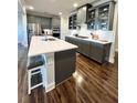 Spacious kitchen featuring an island, quartz countertops and stainless steel appliances at 3615 Faulkner St, Cumming, GA 30041