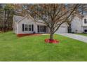 Traditional single-story home with gray siding, black shutters, and a large tree in the front yard at 637 Delay Way, Stockbridge, GA 30281