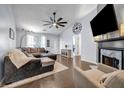 Inviting living room with vaulted ceiling, fireplace, hardwood floors, and modern ceiling fan at 637 Delay Way, Stockbridge, GA 30281