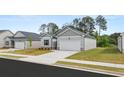 Attractive home featuring a two-car garage, tidy front yard, and complementary landscaping at 8601 Secretariat Dr, Lithonia, GA 30058