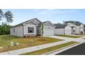 Charming home boasts a manicured lawn, two-car garage, and a welcoming facade at 8601 Secretariat Dr, Lithonia, GA 30058