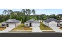A peaceful street scene with similar homes, each featuring a two-car garage and tidy landscaping at 8601 Secretariat Dr, Lithonia, GA 30058