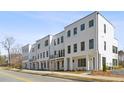 Street view of new, white-brick townhomes showcasing modern architectural design and landscaping at 2150-5 Tidwell Ln # 5, Atlanta, GA 30318