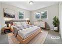 Well-lit bedroom featuring neutral walls, two windows, and stylish decor at 3930 Buck Rd, Powder Springs, GA 30127