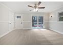 Bright living room with neutral paint, ceiling fan, and sliding glass doors to the backyard at 3930 Buck Rd, Powder Springs, GA 30127