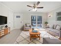 Bright living room with neutral paint, ceiling fan, and sliding glass doors to the backyard at 3930 Buck Rd, Powder Springs, GA 30127