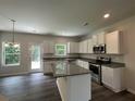 Modern kitchen with white cabinets, granite countertops, stainless steel appliances, and a stylish island at 75 Heyman, Covington, GA 30016