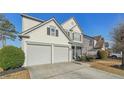 Side view of a two-story home, displaying the two-car garage and well-maintained landscaping at 807 Plaintain Dr, Woodstock, GA 30188