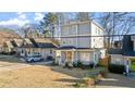 Well-manicured lawn in front of this two story home with front porch and light-gray siding at 1557 Alder Se Ct, Atlanta, GA 30317